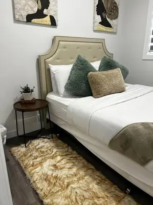 a bedroom with a bed with a fur rug at Gorgeous 6BR New Home for Families in Nisku