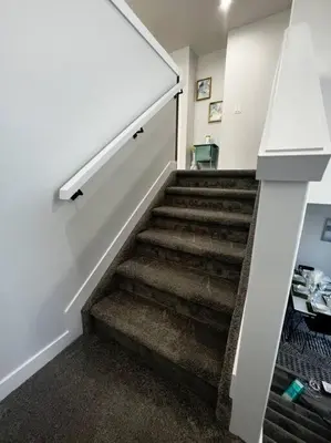 a staircase in a room with a stair case at Gorgeous 6BR New Home for Families in Nisku