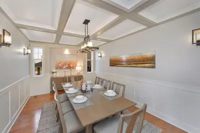 a dining room with a table and chairs and a painting at Mount Finlayson View Villa by EMR Vacation Rentals in Victoria