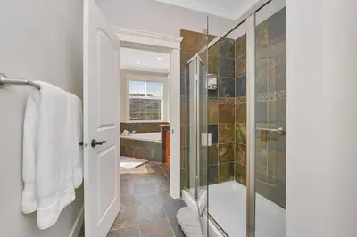 a bathroom with a walk in shower and a glass shower stall at Mount Finlayson View Villa by EMR Vacation Rentals in Victoria
