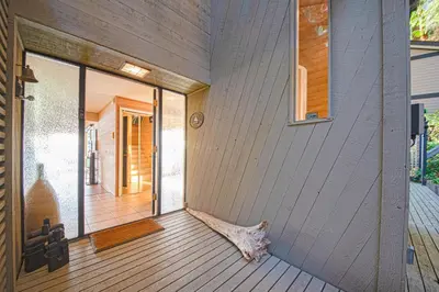 a front porch of a house with a wooden door at SALT COTTAGE Waterfront Guest House with Superb Views in West Vancouver