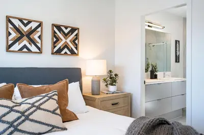 a bedroom with a bed and a bathroom at The Big Deck by Revelstoke Vacations in Revelstoke