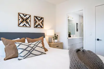 a bedroom with a white bed with pillows at The Big Deck by Revelstoke Vacations in Revelstoke