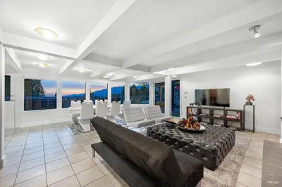 a living room with a couch and a table at Seymour Private Bedroom, Ensuite Bathroom with Shared Pool, Hot Tub with Views in North Vancouver