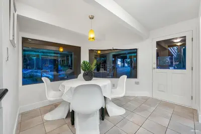 a dining room with a white table and white chairs at Cypress: Private Bedroom/Bathroom/Office, with Shared Pool, Hot tub in North Vancouver