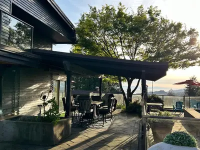 a patio with a table and chairs on a house at Cypress: Private Bedroom/Bathroom/Office, with Shared Pool, Hot tub in North Vancouver