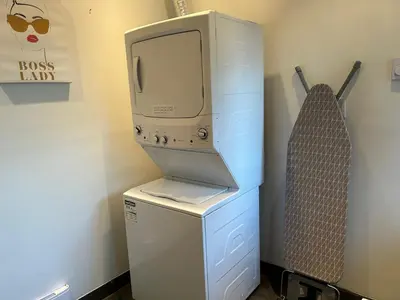 a computer sitting on top of a washer and dryer at Cypress: Private Bedroom/Bathroom/Office, with Shared Pool, Hot tub in North Vancouver