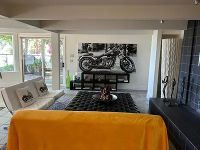 a living room with a motorcycle on the wall at Cypress: Private Bedroom/Bathroom/Office, with Shared Pool, Hot tub in North Vancouver