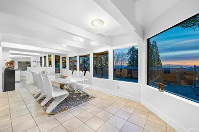a dining room with a table and chairs and large windows at Cypress: Private Bedroom/Bathroom/Office, with Shared Pool, Hot tub in North Vancouver