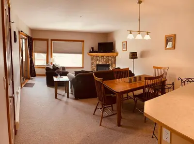 a living room with a table and a dining room at Wanna get away in the Rocky Mountains in Canmore