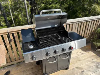 a barbecue grill sitting on a wooden deck at Brown's Beach Guest Suite in Ucluelet