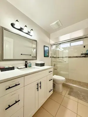 a bathroom with a toilet and a sink and a shower at Burnaby Metrotown Cozy 3 Bedroom Suite Walk to Skytrain and Malls in Burnaby