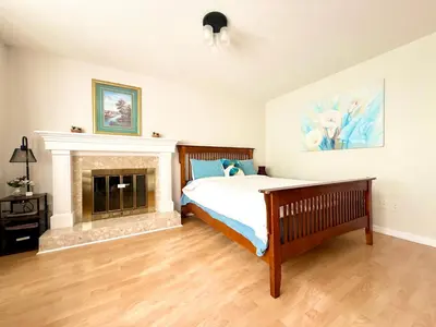 a bedroom with a bed and a fireplace at Burnaby Metrotown Cozy 3 Bedroom Suite Walk to Skytrain and Malls in Burnaby