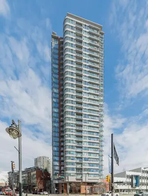 a tall building with many windows in a city at GardenView Modern Condo with Parking, Gym, Pool, AC in Vancouver