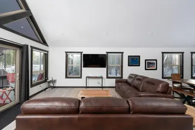 a living room with a brown leather couch at The Sundance Cabin in Valemount