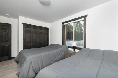 a bedroom with two beds and a window at The Sundance Cabin in Valemount