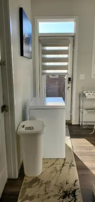 a bathroom with a white toilet in a room at Delightful 1-bedroom Private Suite in a New Home in Calgary