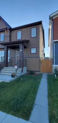 a house with a sidewalk in front of it at Delightful 1-bedroom Private Suite in a New Home in Calgary