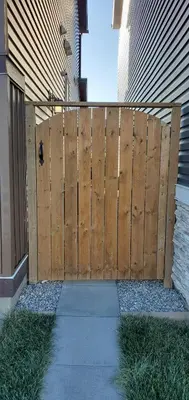 a wooden fence in front of a house at Delightful 1-bedroom Private Suite in a New Home in Calgary