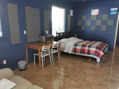 a bedroom with a bed and a table and chairs at Nini Sweet home in Richmond