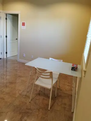 a white table and chairs in a room at Nini Sweet home in Richmond