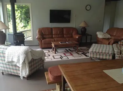 a living room with a couch and a table at Argo's Landing in Bamfield