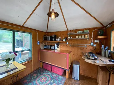 a kitchen with a counter and a table in a room at Funky Bunky in Nelson