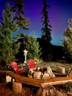 two red chairs and a fire pit in a yard at Funky Bunky in Nelson