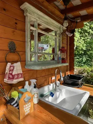 a kitchen sink in a cabin with a window at Funky Bunky in Nelson