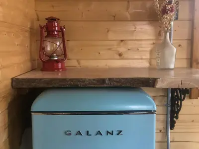 a table with a red lantern on top of a cooler at Boho Bungalow in Nelson