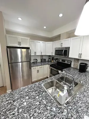 a kitchen with a sink and a stainless steel refrigerator at Stay In The Okanagan - Copper Sky, West Kelowna in West Kelowna