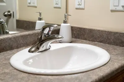 a bathroom sink with a chrome faucet on a counter at Polar Peaks Hot Tub Pool Gas Fireplace in Radium Hot Springs