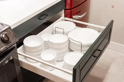 a drawer filled with plates and bowls in a kitchen at Vancouver Nest Downtown 2BR near Rogers Arena in Vancouver