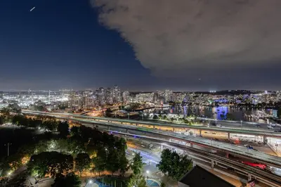 a view of a city at night with trains at Vancouver Nest Downtown 2BR near Rogers Arena in Vancouver