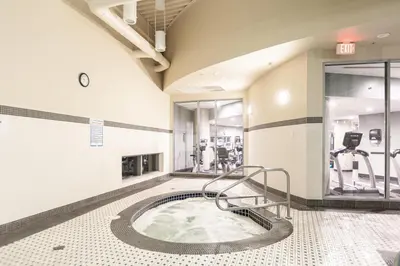 a gym with a hot tub in the middle of a room at Vancouver Nest Downtown 2BR near Rogers Arena in Vancouver