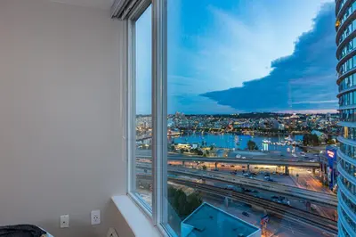 a large window with a view of a city at Vancouver Nest Downtown 2BR near Rogers Arena in Vancouver