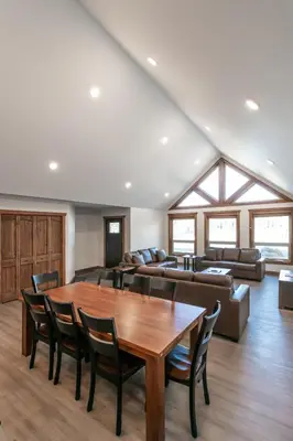 a living room with a table and a couch at The Evergreen Cabin in Valemount