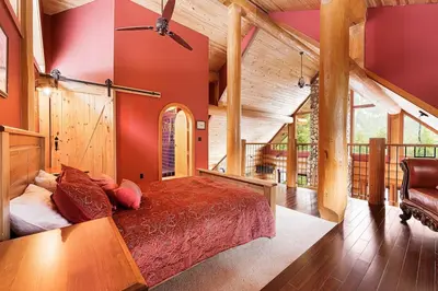 a bedroom with a large bed in a house at Gem by Manning Park: Luxury Loghouse “Ravenloft” in Sunshine Valley