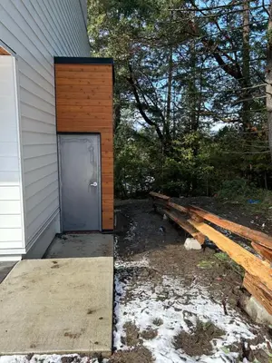 a building with a door on the side of a house at Victoria private studio suite in Victoria